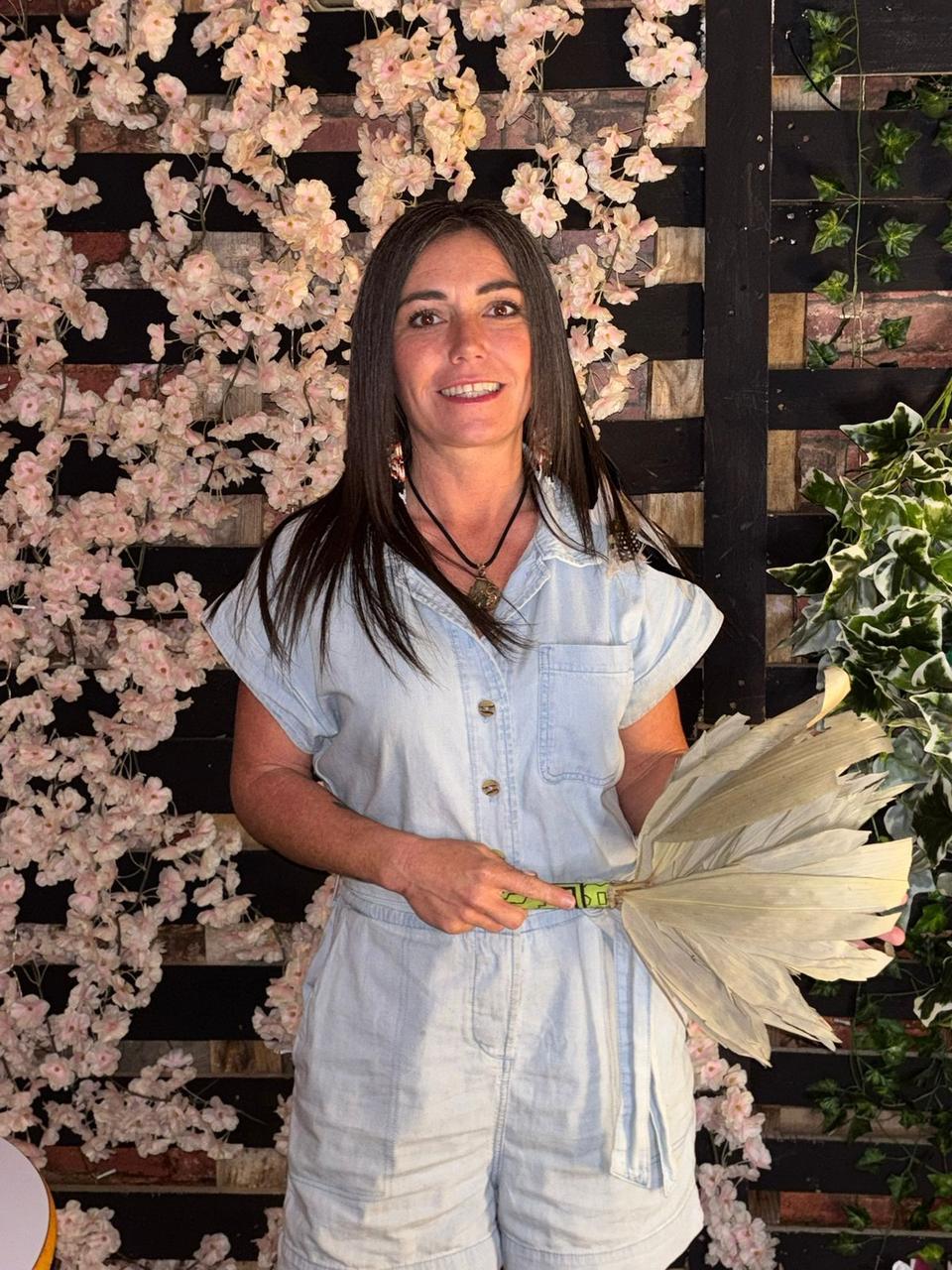 Claire smiling against a cherry blossom wall