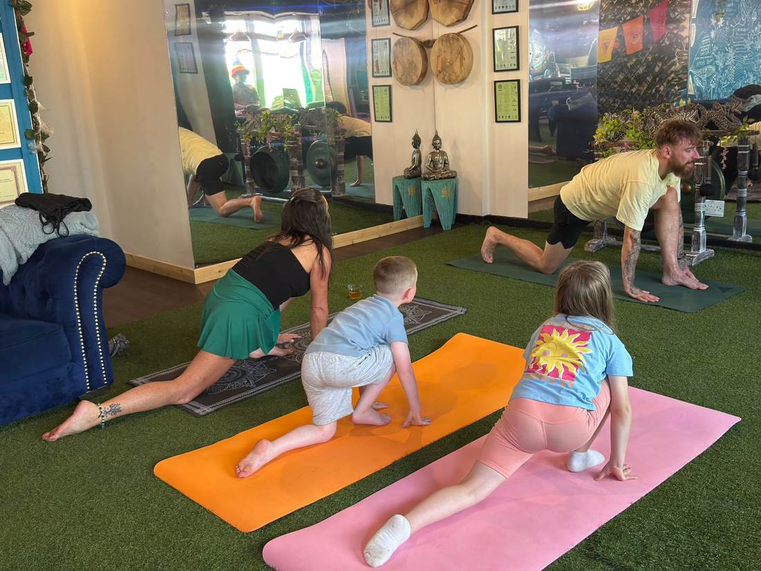 A family stretching together in Nicky's yoga class